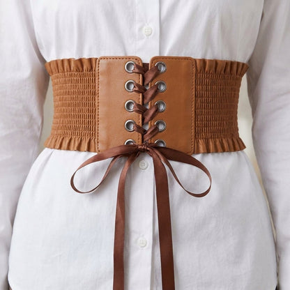 Close up of the silver eyelets and satin bow on the lace up corset belt
