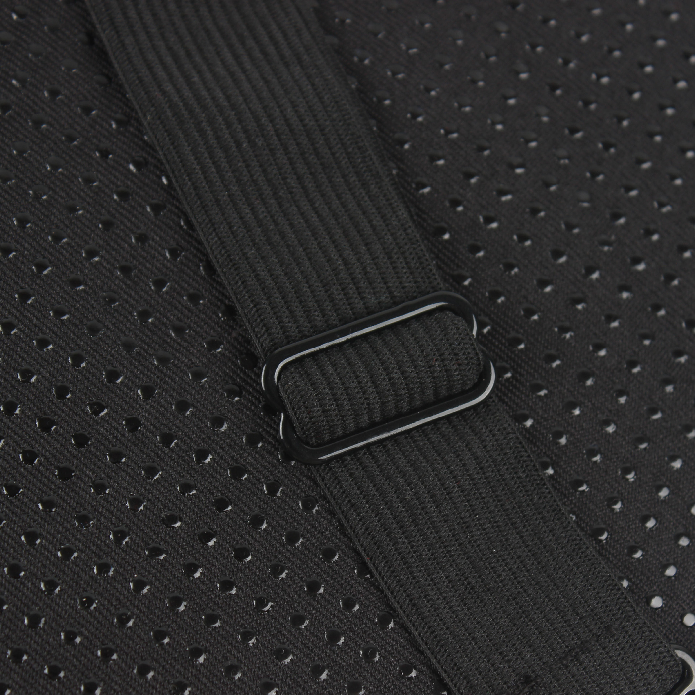 A close up of a black Motorcycle Seat Cushion Pad with a metal buckle providing shock absorption.
