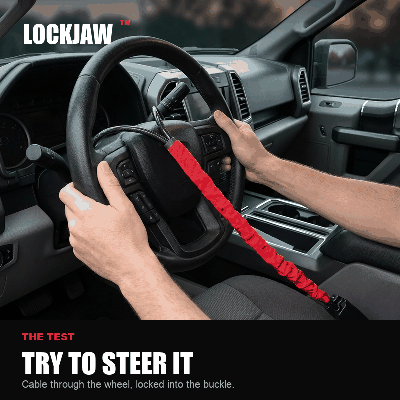Hands trying to turn the steering wheel with the LOCKJAW fitted - it stops after a few degrees