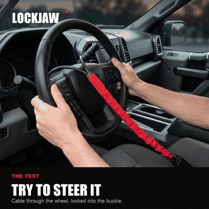 Hands trying to turn the steering wheel with the LOCKJAW fitted - it stops after a few degrees