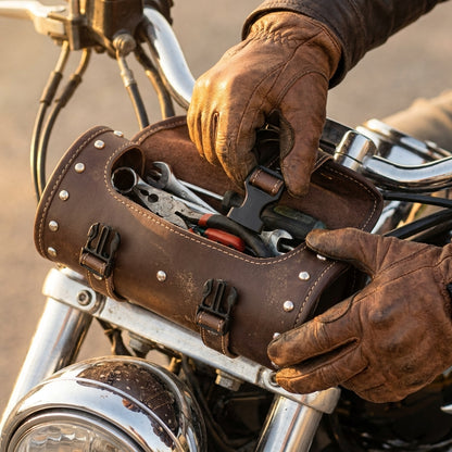 Rider opening the leather tool pouch to reach the tools inside