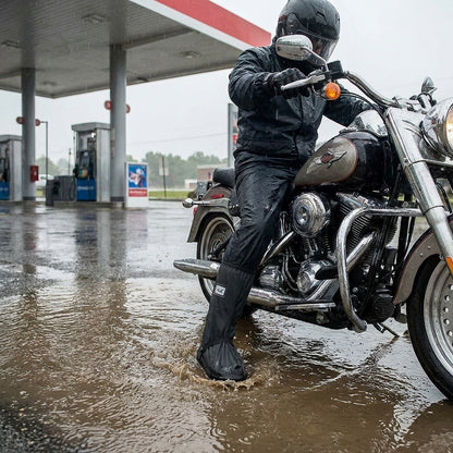 Rider stepping into a puddle wearing waterproof boot covers