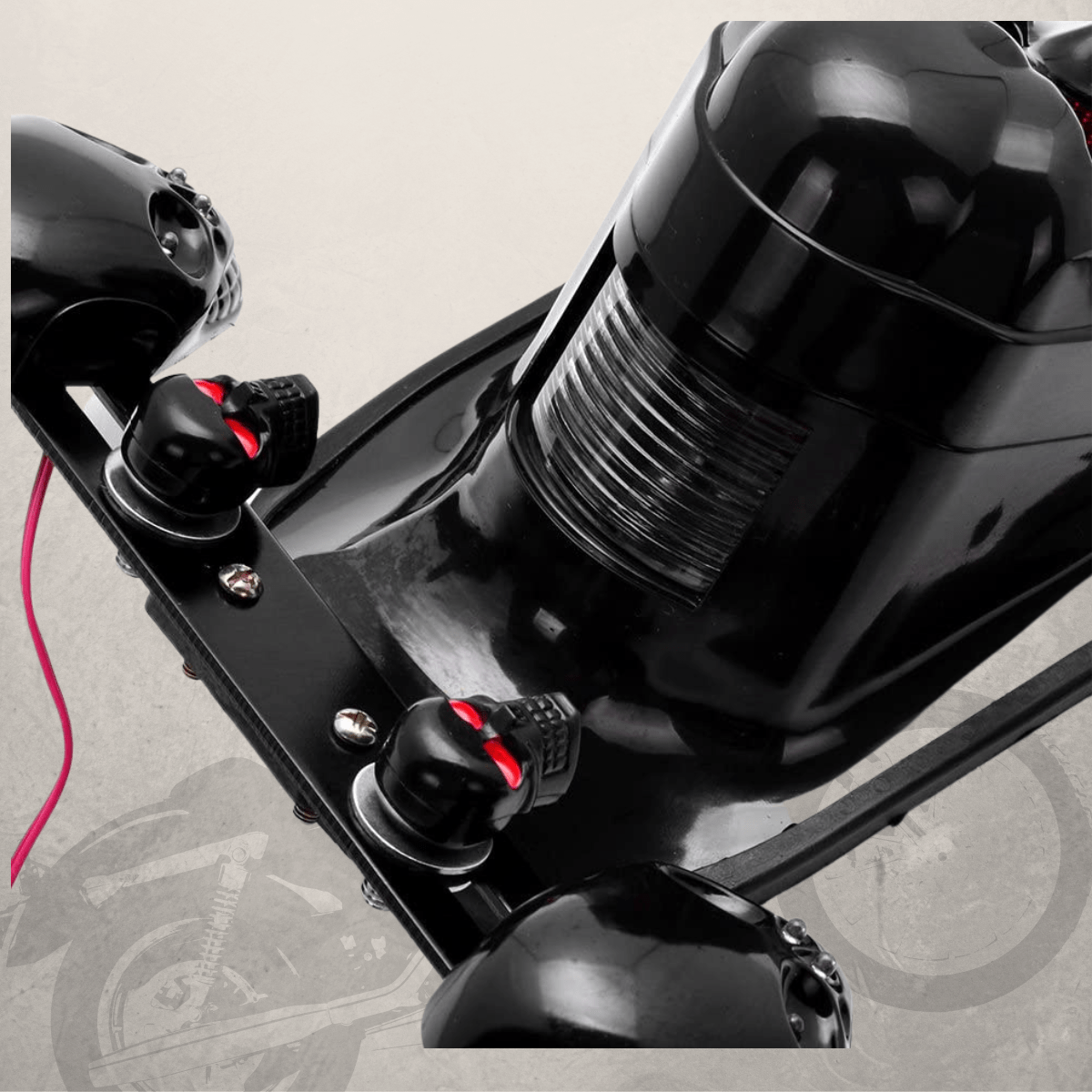 A close up of a black scooter with a pink handlebar and Motorcycle Skull Tail Lights with Turn Signals.