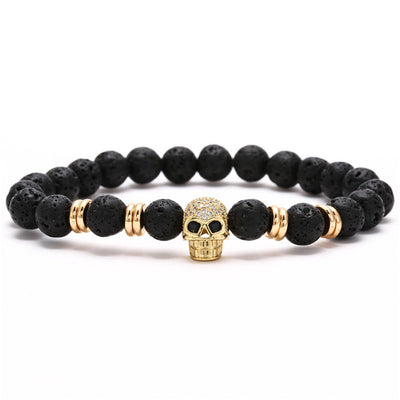 A gold Skull Bracelet for Bikers, 8 in with black lava beads.