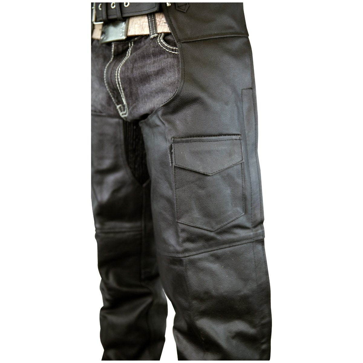 Close-up of a person wearing Vance Leather Zip-Out Insulated and Lined Plain Biker Leather Chaps, Unisex, featuring visible pockets and detailed stitching. The chaps are paired with a belt, and a portion of a black jacket is visible at the top.