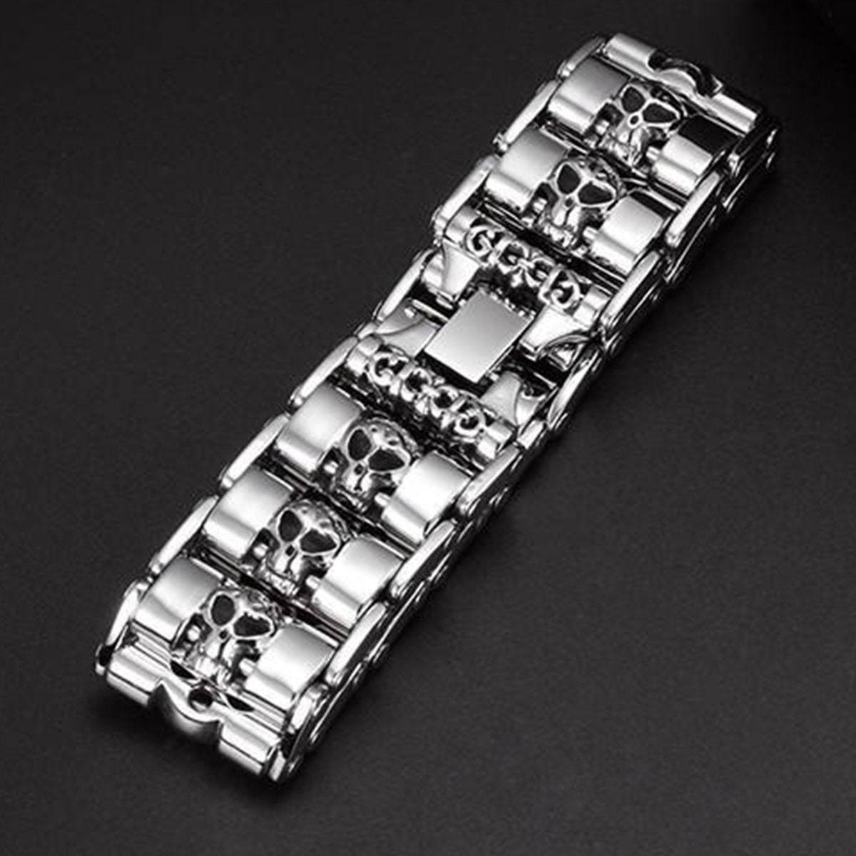 A Stainless Steel Fashion Wide Skull Bracelet, 8.3 x 0.9 in, featuring multiple skull-shaped links against a black background.