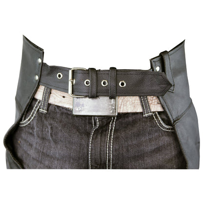 A close-up of a person wearing dark jeans with white stitching and a wide black belt with a silver buckle, partially covered by Vance Leather Zip-Out Insulated and Lined Plain Biker Leather Chaps, Unisex.