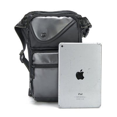 Styled with a silver iPad displaying the iconic Apple logo, the Men's Multi-Function Chest/Waist Bag is a versatile black accessory featuring multiple compartments.