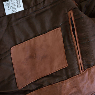 A close up of a Vance Cafe Racer Austin Brown Leather Jacket with a pocket.