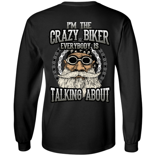 The "I'm The Crazy Biker Long Sleeves" is a black long-sleeve shirt showcasing an illustrated bearded biker with goggles and the text "I'm the crazy biker everybody is talking about." Made from 100% cotton and available in unisex sizing, this digital print design offers both comfort and style.