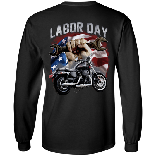 The Labor Day Long Sleeve T-Shirt, designed with a "Labor Day" theme showcasing a hand holding a wrench, an American flag backdrop, and a motorcycle. This unisex shirt offers comfort with its 100% cotton fabric.