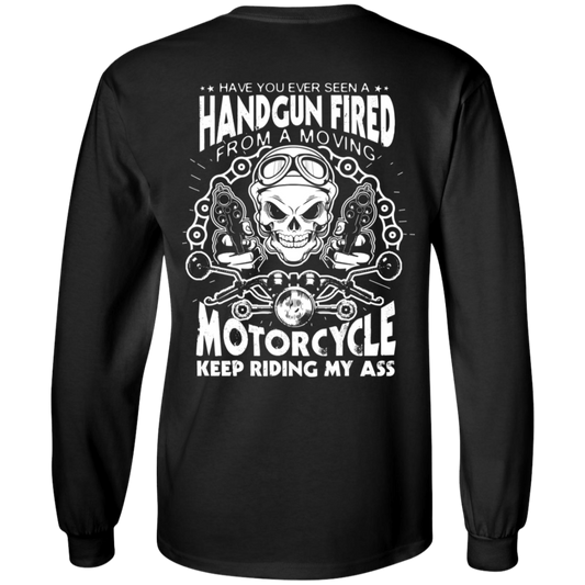 Introducing the Motorcycle Keep Riding My Ass Long Sleeves: a black, 100% cotton shirt featuring a white graphic with the text "Have you ever seen a handgun fired from a moving motorcycle? Keep riding my ass." The design showcases a skull and crossed pistols, and unisex sizing guarantees it fits everyone perfectly.