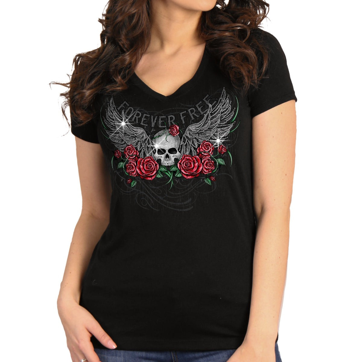 A person in a Hot Leathers Ladies Skull Wing Roses T-Shirt with a "FOREVER FREE" logo, skull, wings, and red roses graphic printed in metallic purple ink, standing with one hand in their pocket.