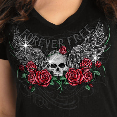 The Hot Leathers Ladies Skull Wing Roses T-Shirt is a full-length tee featuring a skull with wings and red roses, accentuated with metallic purple ink and the text "FOREVER FREE." Made from 100% cotton for ultimate comfort.