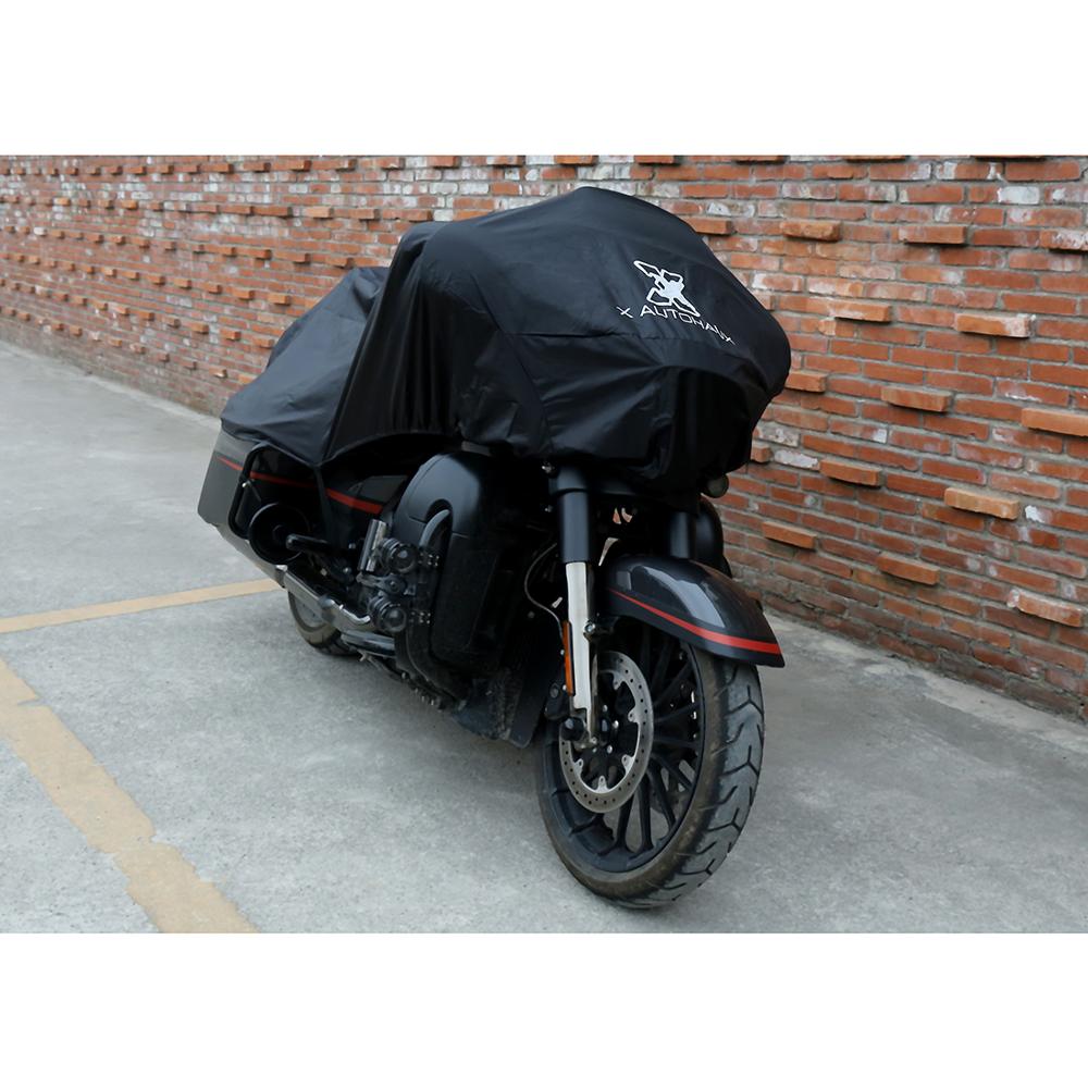 Next to a brick wall on a concrete surface, a motorcycle is protected by the optimal design of the Waterproof Motorcycle Half Cover, crafted from durable 210T polyester fabric.