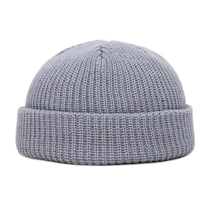 A Wool Knitted Skull Cap Beanie, made of grey knit fabric, on a white background.