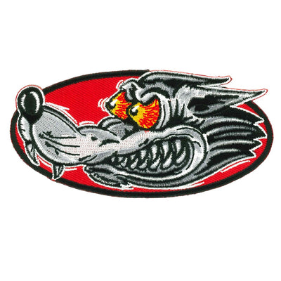 The Hot Leathers 4" Race Wolf Patch showcases an embroidered design of a fierce wolf with bared teeth and glowing yellow eyes, set against a red oval background, perfect for iron-on applications.