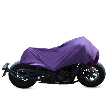 A purple Motorcycle Half Cover made from 210T polyester fabric is draped over a motorcycle, discreetly concealing its details while offering reliable protection, leaving only the wheels and part of the frame visible.