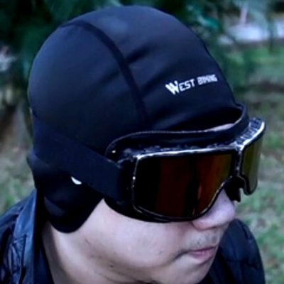 A man wearing a Motorcycle Helmet Liner Cap that provides cooling sweat management.