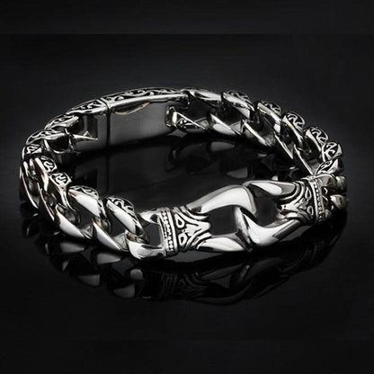 A Stainless Steel Vintage Charm Bracelet for Bikers with intricately designed links and a clasp featuring ornate patterns is displayed against a black background, embodying the allure of modern medieval fantasy jewelry.