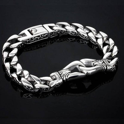 A modern medieval fantasy jewelry piece, this Stainless Steel Vintage Charm Bracelet for Bikers features intricate designs on the clasp and links, set against a black background.