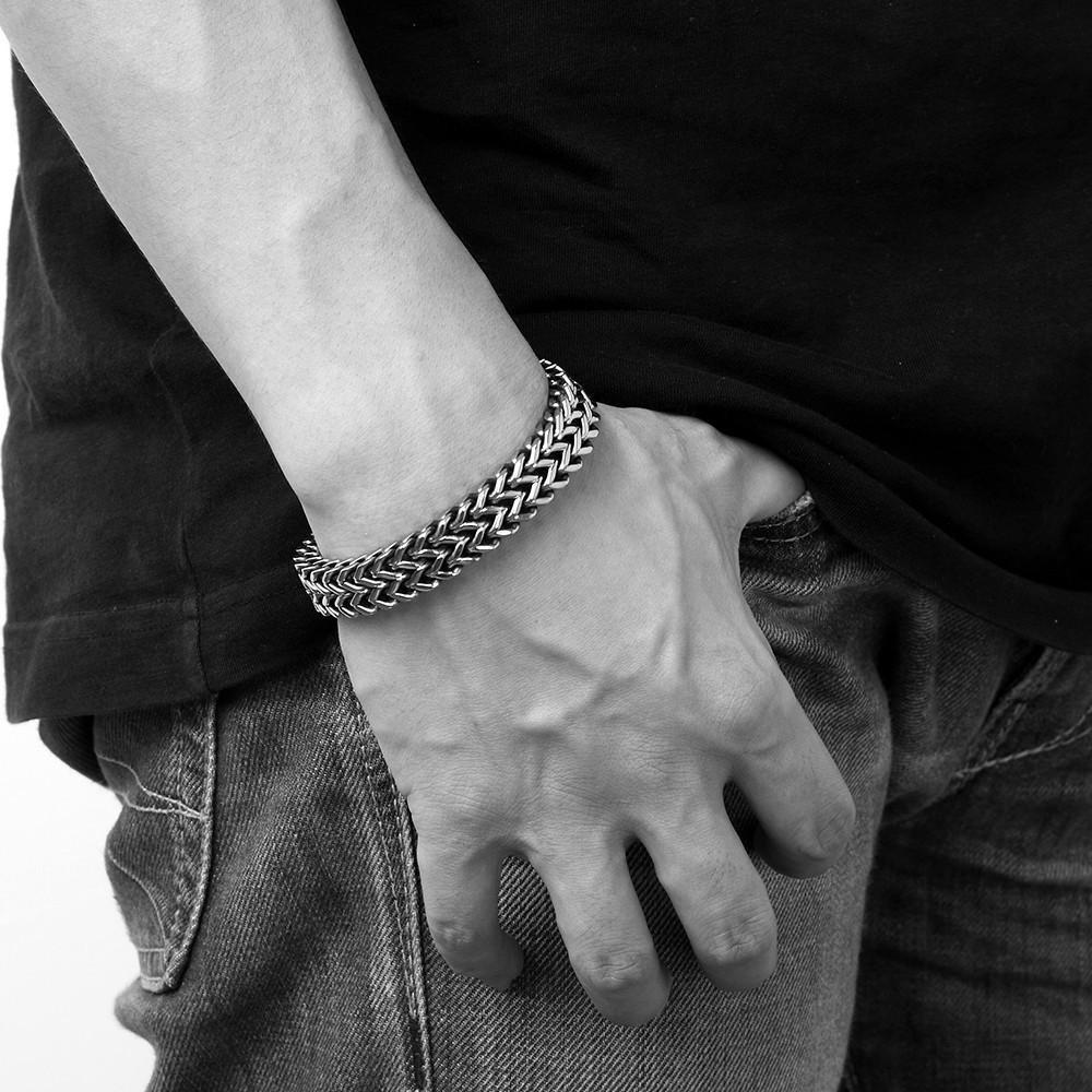 A black and white photo of a man wearing a Stainless Steel Double Side Snake Chain Bracelet.