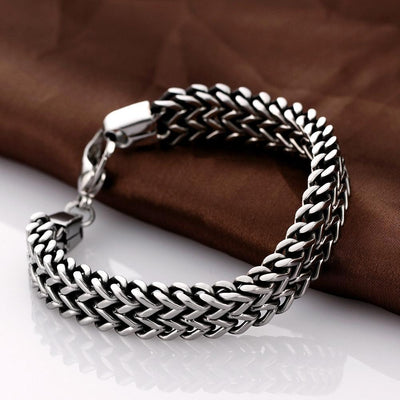 A Stainless Steel Double Side Snake Chain Bracelet on a brown cloth.