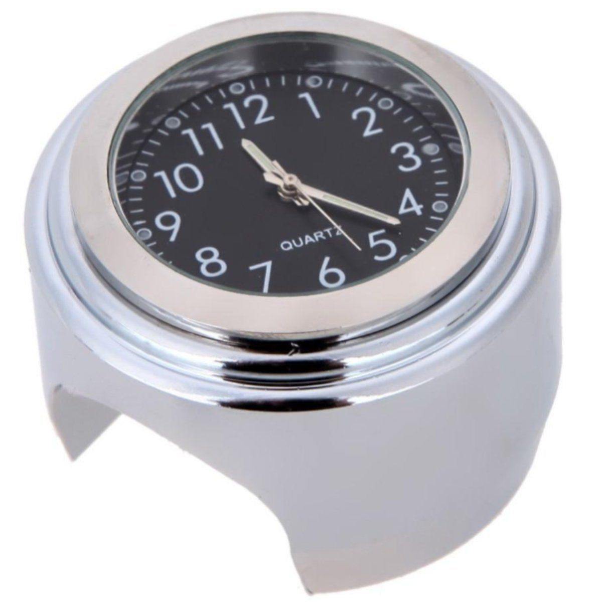 A small round analog Motorcycle Handlebar Clock with Motorcycle Phone Mount Bundle, featuring a black face, white numbers, and silver casing, mounted on a reflective metal stand with a cutout base. Crafted from premium-quality aluminum alloy for durability and style.