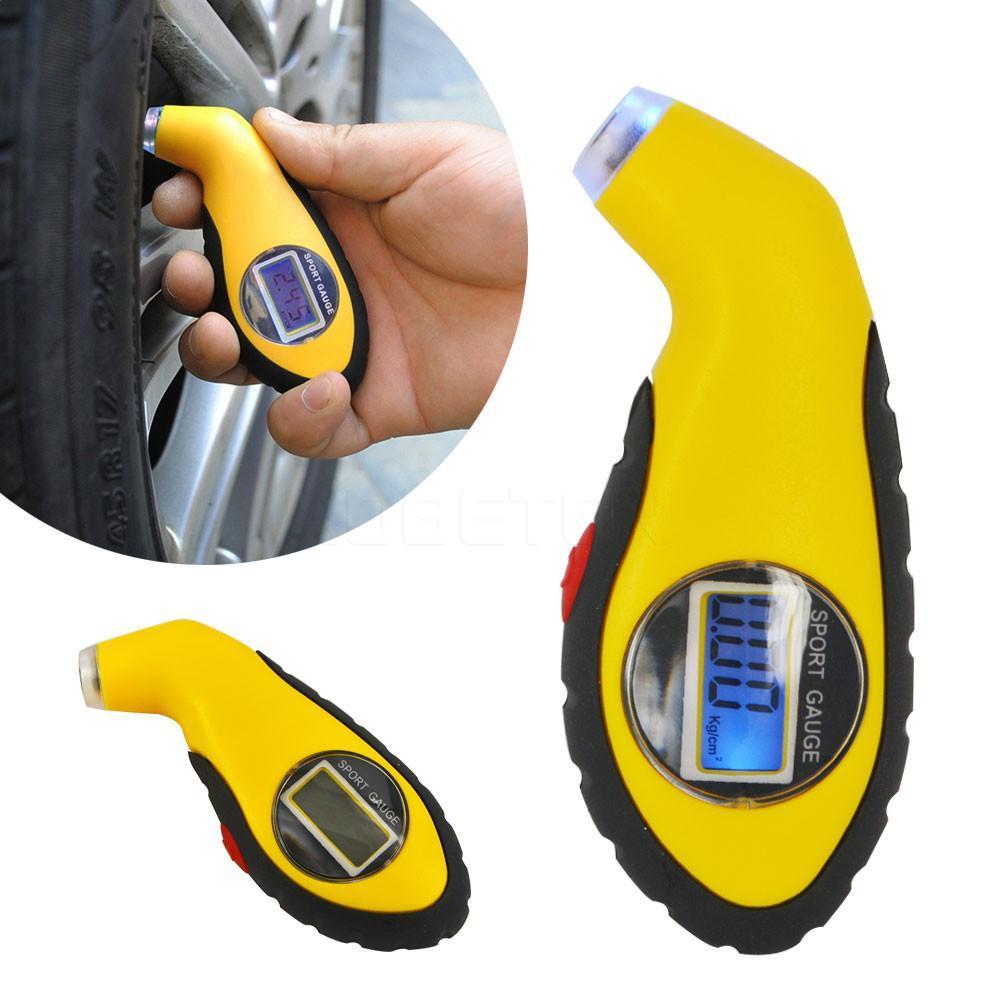 A digital Tire Pressure Tester with a hand holding it.
