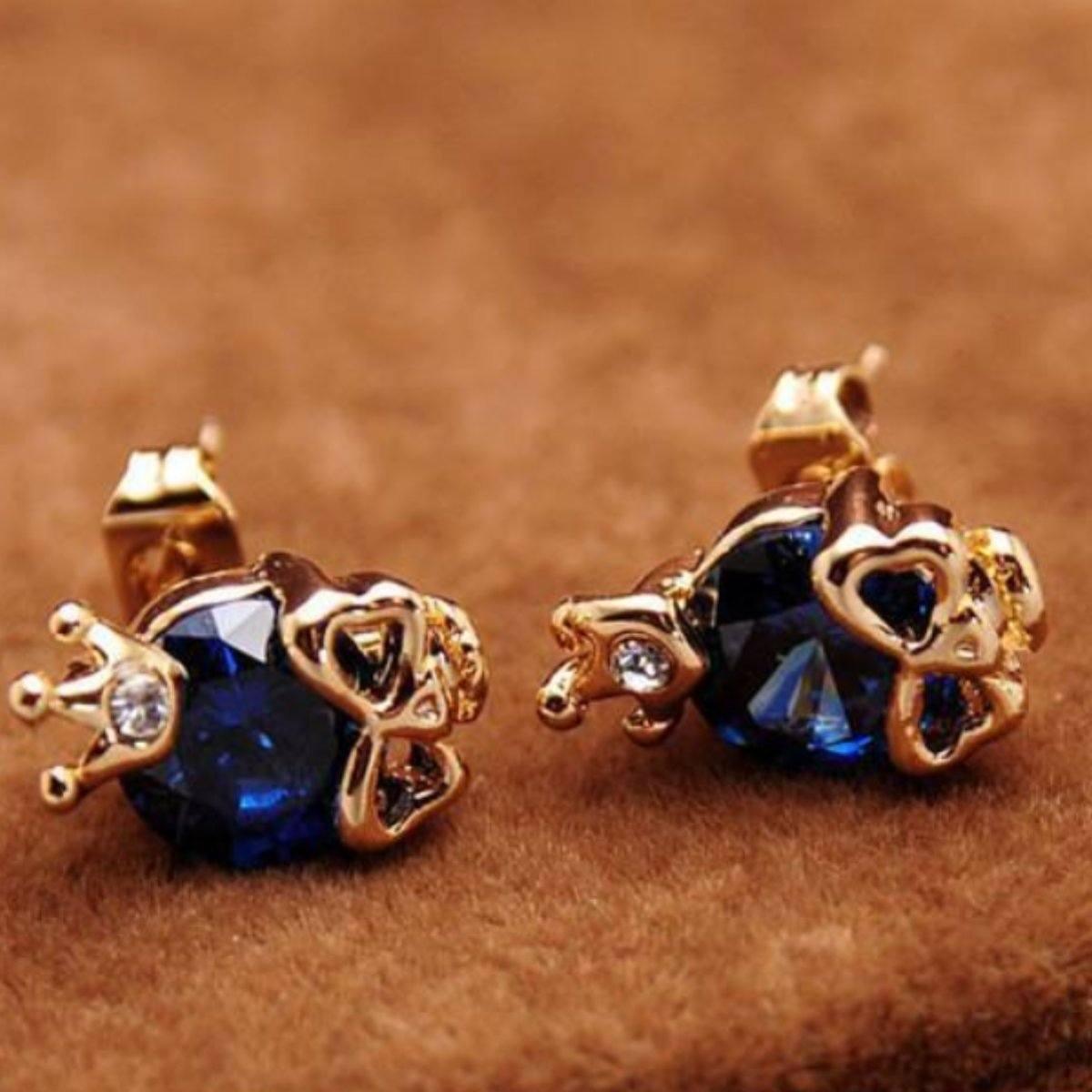 A pair of Woman's Gold Plated Skull Cubic Zircon Stud Earrings with blue crystals.