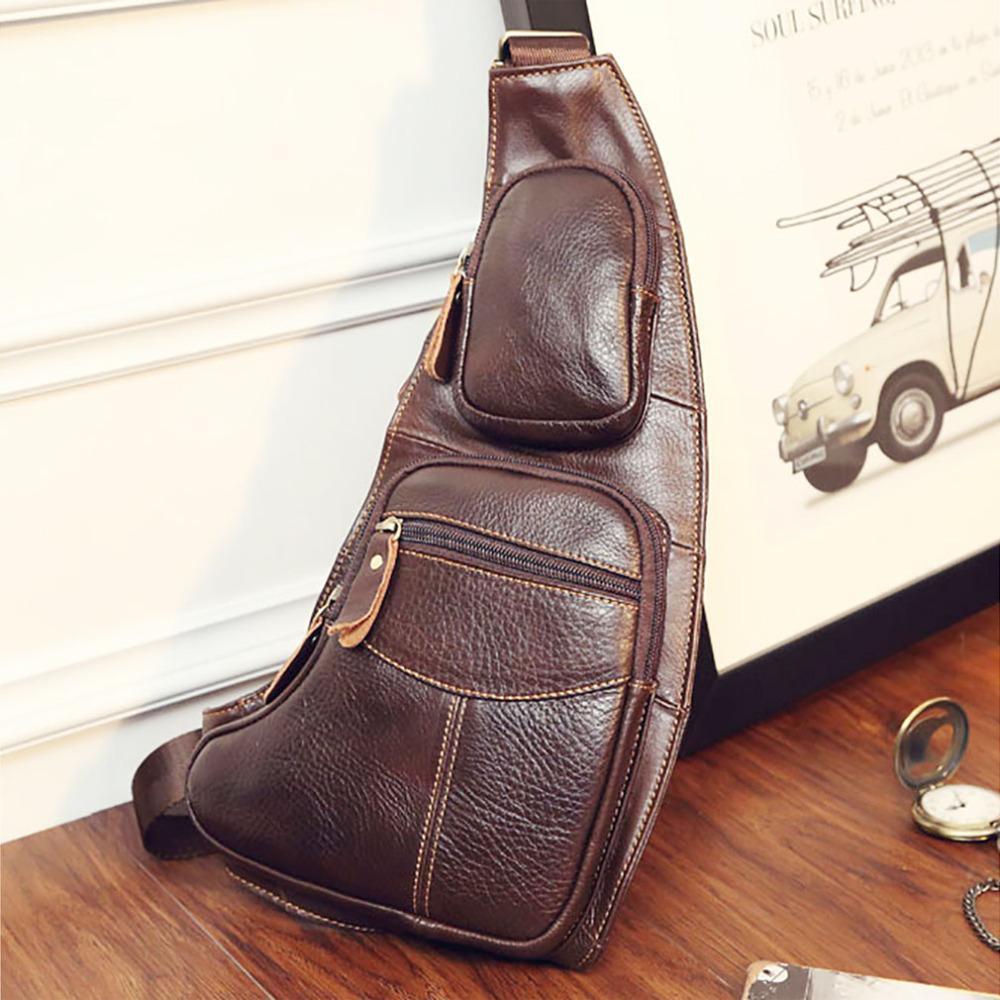 A Leather Sling Chest Bag sitting on a wooden table.