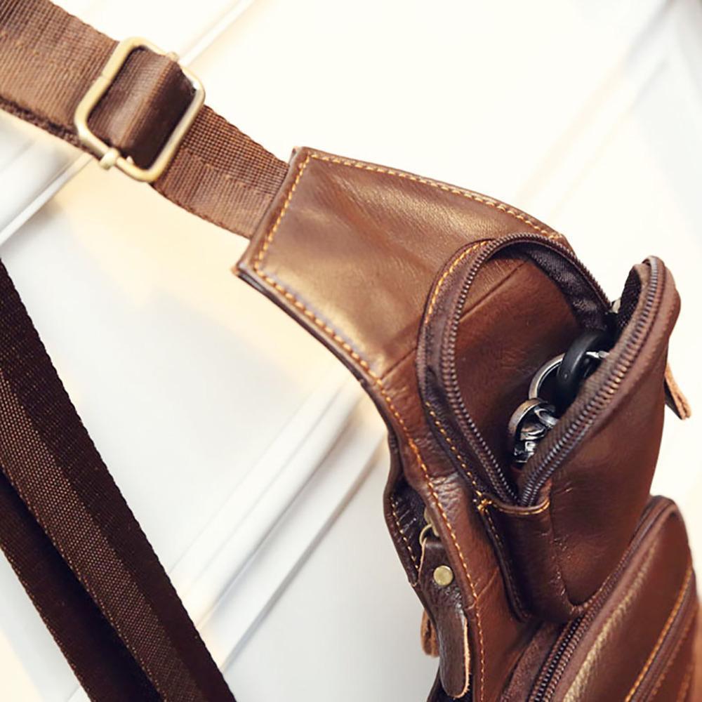 A brown genuine Leather Sling Chest Bag hanging on a wall.
