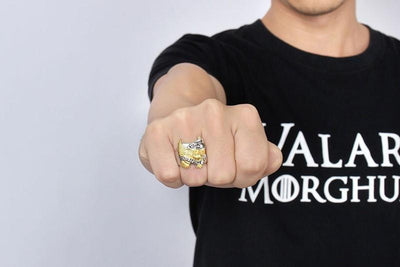 A man wearing a t-shirt with a Live to Ride Ring on his finger.