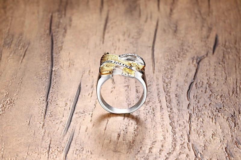 A Live to Ride Ring on top of a wooden table.