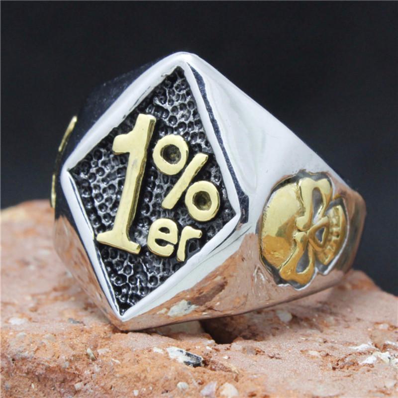 A Titanium Steel 1% Er Skull Handmade Biker Ring with a shamrock on it.