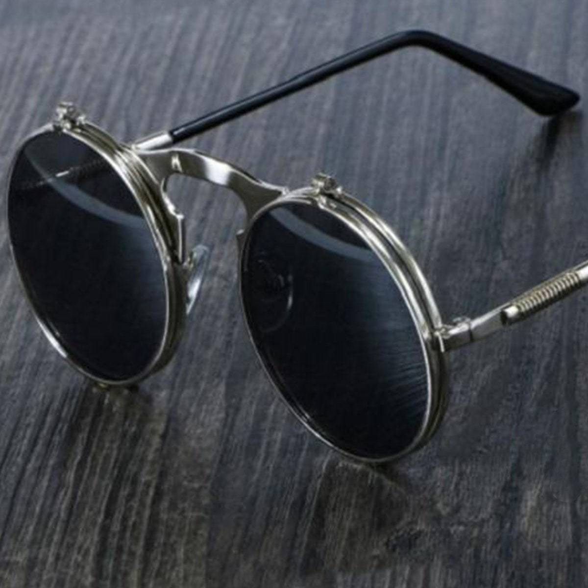 Iconic Steampunk Flip-Up Round Double Lens sunglasses on a wooden table.
