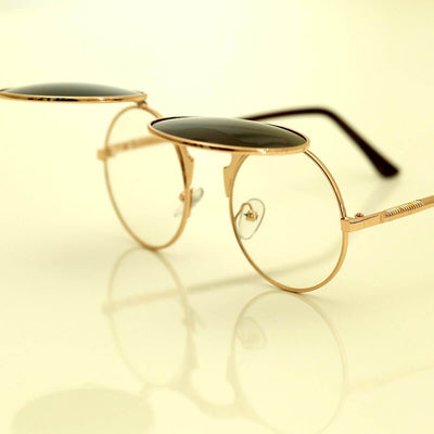 A pair of Steampunk Flip-Up Round Double Lens Sunglasses on a white surface.