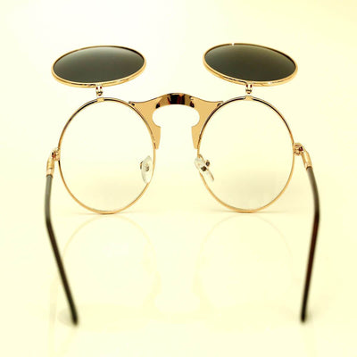 A pair of Steampunk Flip-Up Round Double Lens Sunglasses with a gold rim on a white surface.