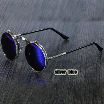 A pair of Steampunk Flip-Up Round Double Lens Sunglasses on a wooden table.