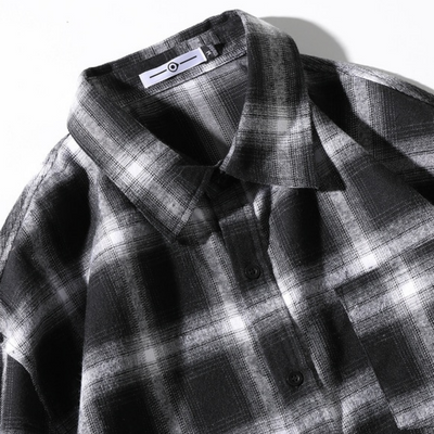 A Men's Classic Plaid Flannel Shirt, Black/White hanging on a white surface.