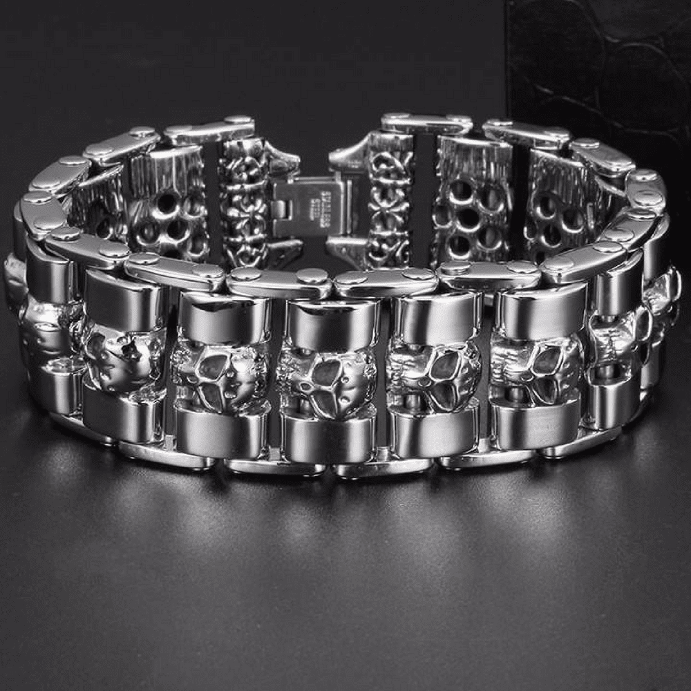 A Stainless Steel Fashion Wide Skull Bracelet, 8.3 x 0.9 in featuring a pattern of small skull designs arranged around the band, displayed against a black background. The medieval style bracelet combines classic charm with an edgy twist.
