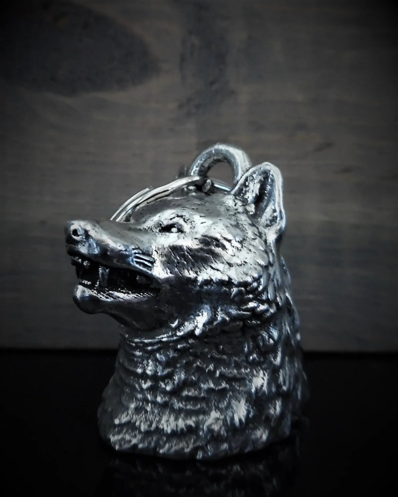 The Daniel Smart Wolf Head Guardian Bell, a detailed, lead-free pewter figurine depicting the head of a snarling wolf against a dark backdrop, arrives in a lavish velveteen drawstring black bag. This exquisite piece is part of the exclusive Bravo Bells collection.