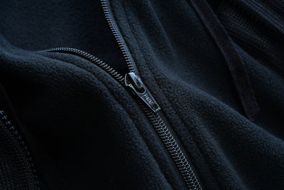 Close-up of a zipper on the Daniel Smart Women's Mesh 3-in-1 Riding Jacket (Black/Orange).