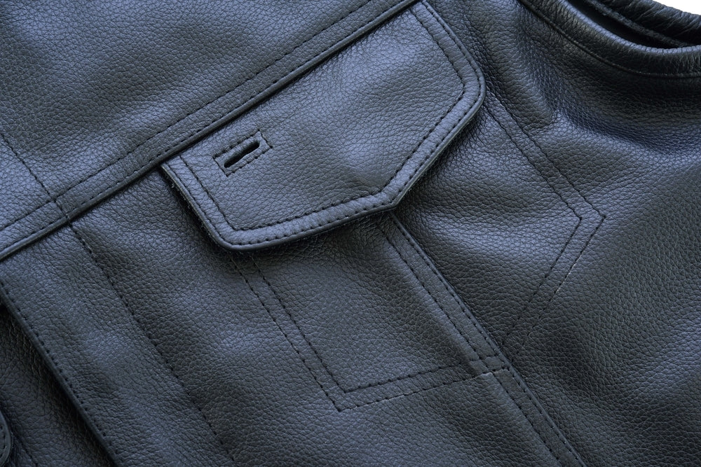 Close-up of a Daniel Smart Concealed Snap Closure, Without Collar & Hidden Zipper showing a detailed pocket with a flap and stitching patterns on a textured surface, designed as part of premium biker gear.