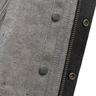 Close-up of the inside seam of the black First Manufacturing Rook men's motorcycle denim vest, showcasing intricate stitching details and sturdy metal rivets.