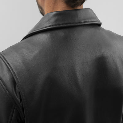 The back view of a man wearing the First Manufacturing Jay Men's Leather Jacket with a motorcycle style.
