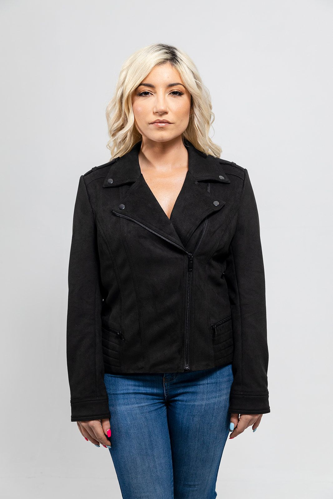 A woman wearing jeans and a First Manufacturing Molly - Women's Leather Jacket with horizontal zipper pockets.