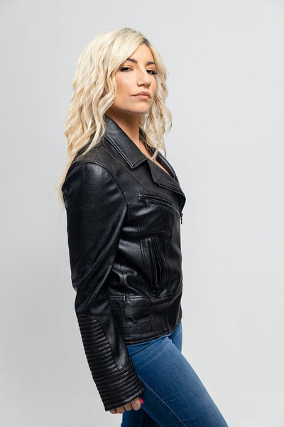 A woman sporting a First Manufacturing Lauren - Women's Vegan Leather Jacket, Black with an asymmetrical zipper, paired with jeans.