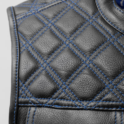 A close up of a First Manufacturing Upside Leather Vest with blue stitching.