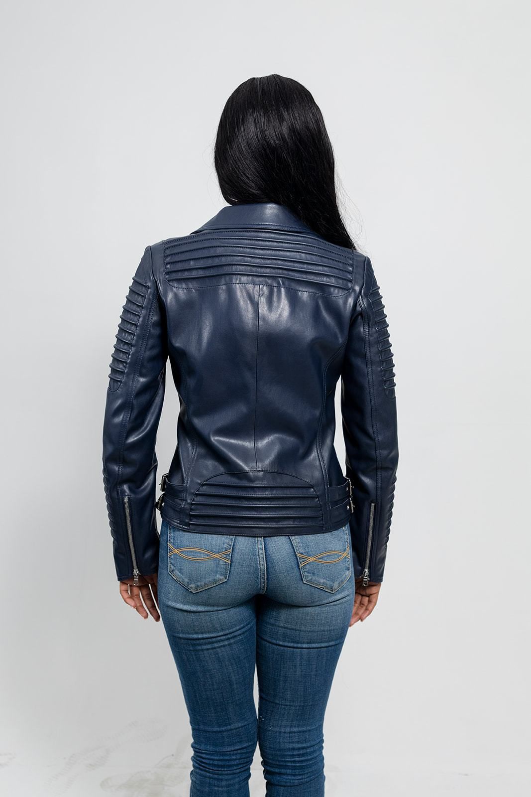 The back view of a woman wearing the First Manufacturing Paris - Women's Vegan Leather Jacket, Navy Blue featuring exposed zippers.
